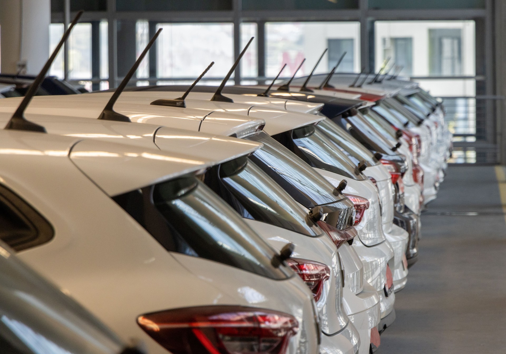 Used car sales Cars in a row Car Dealer Inventory Indoor garage